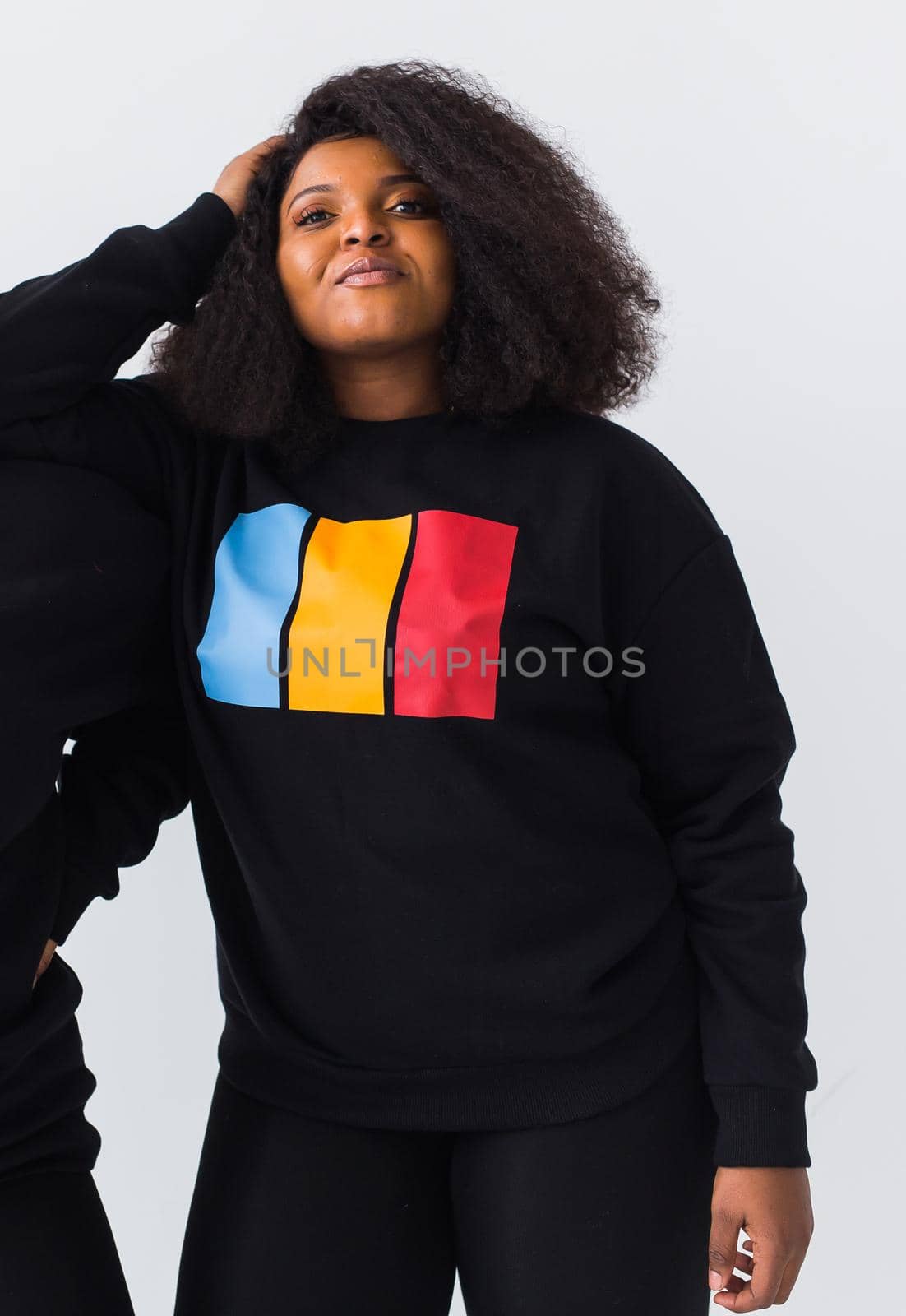 Young beautiful african american girl with an afro hairstyle. Portrait on white background. Girl looking at camera. by Satura86