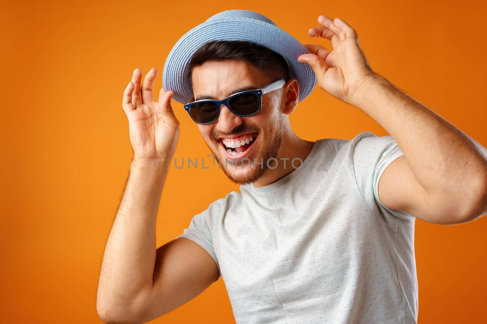 Overjoyed funny bearded man in glasses celebrating success close up.