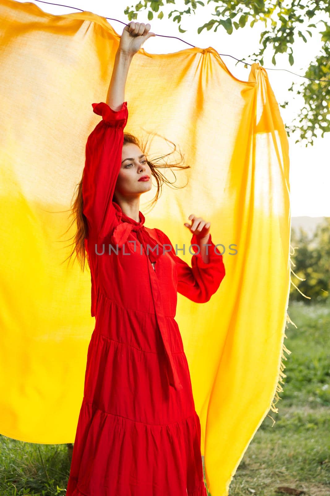 festively outdoors yellow cloth on the background of posing red dress. High quality photo