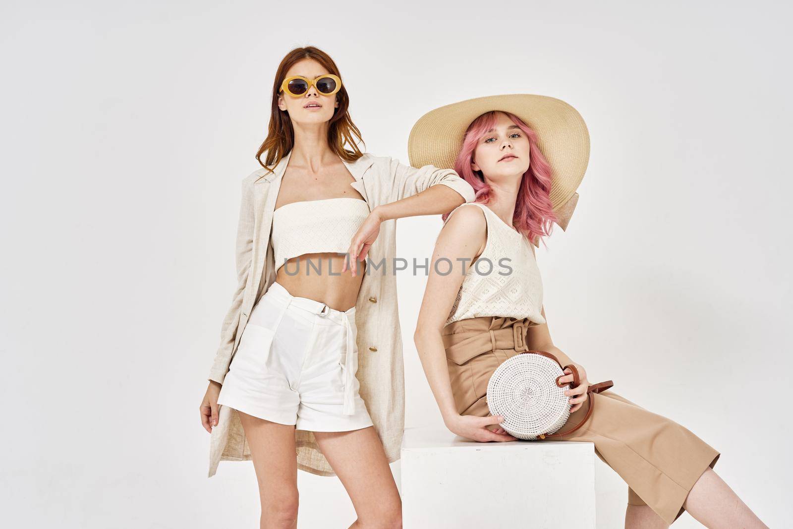 two women in fashionable clothes posing model decoration. High quality photo