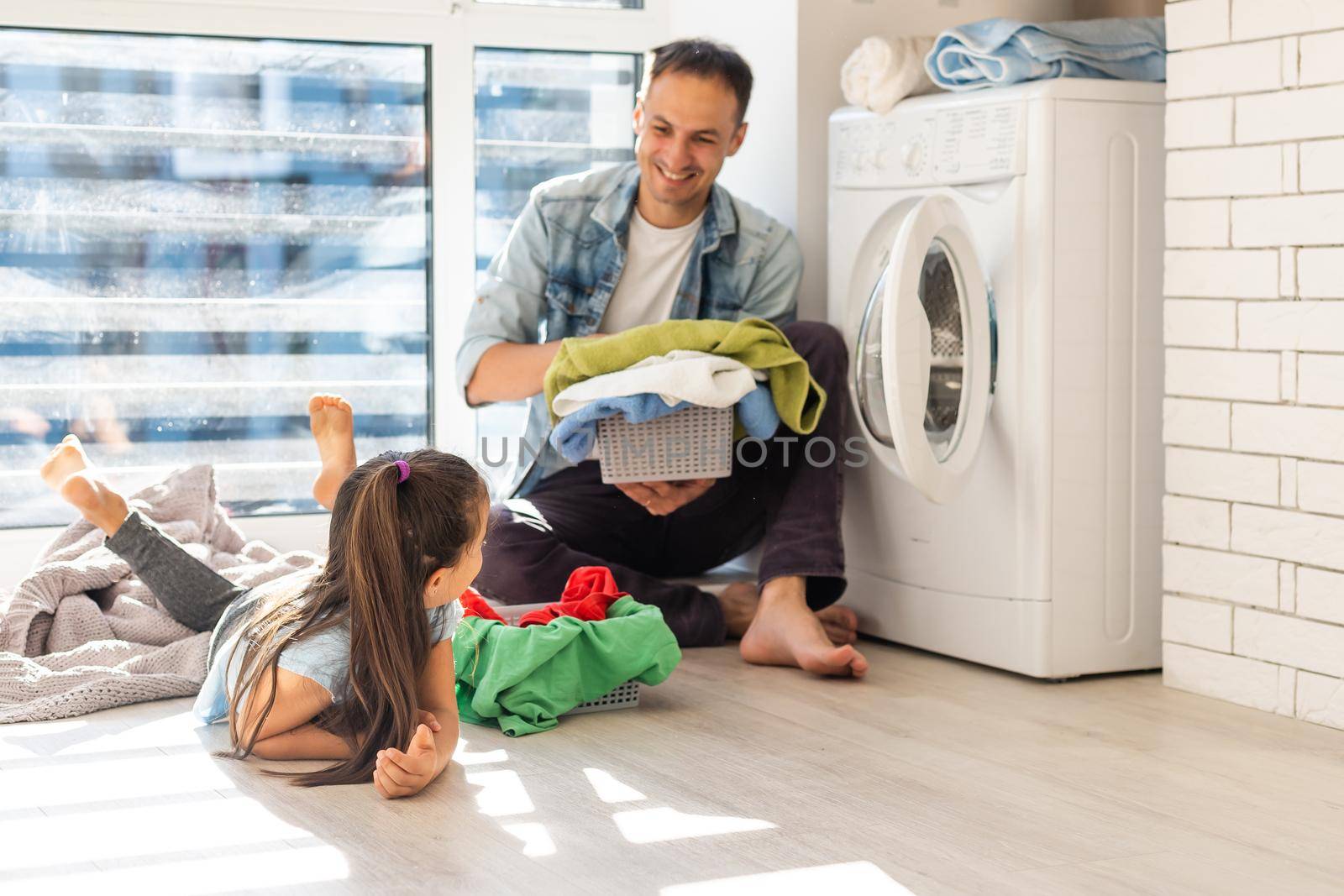 happy casual multiethnic family laundry clothes at home