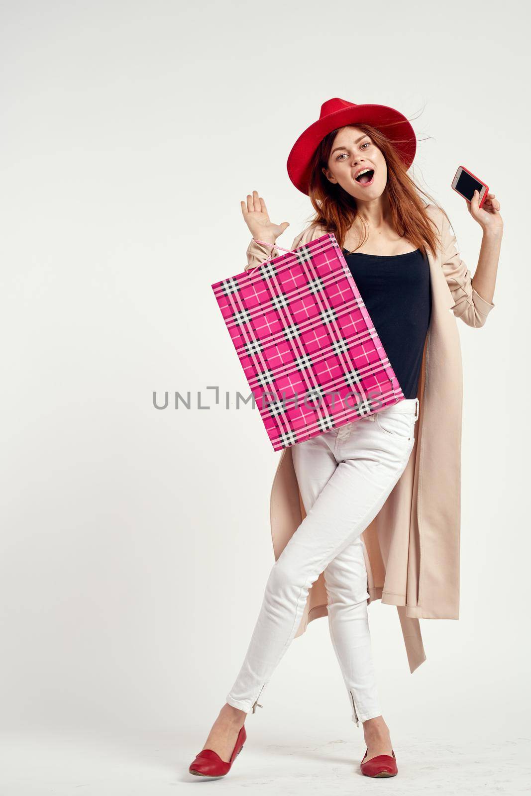 beautiful woman wearing a red hat posing shopping fun light background. High quality photo