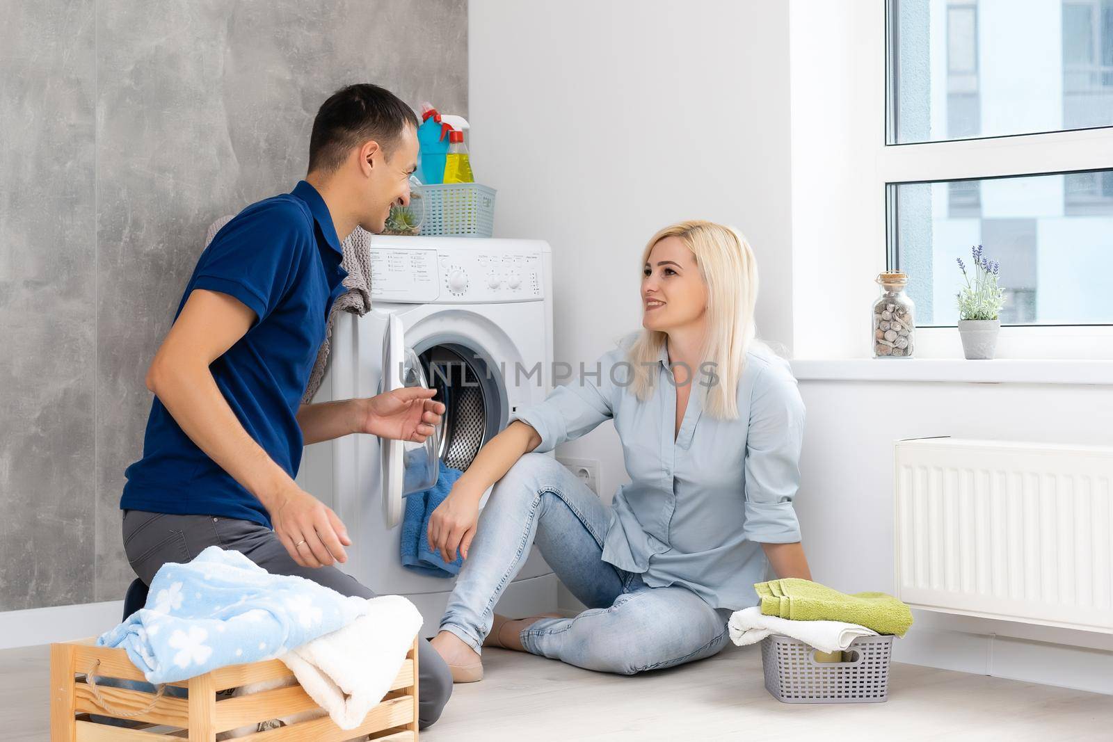 man and woman with washing machine in apartment
