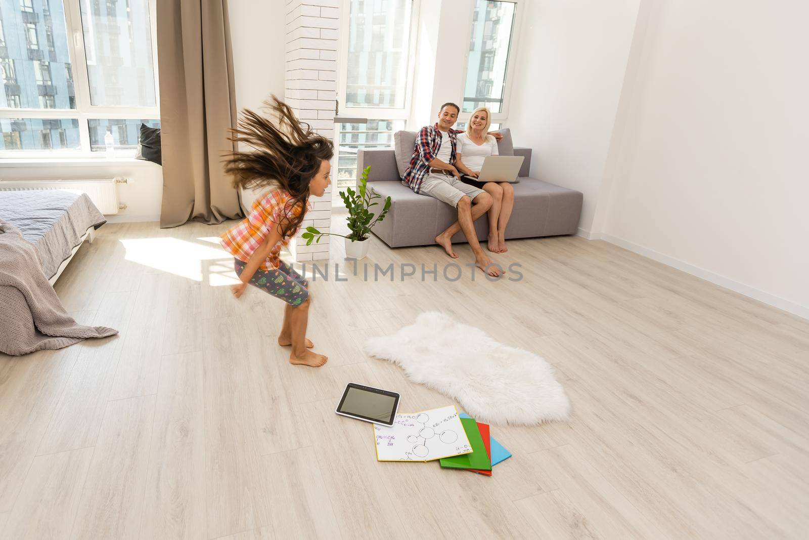 8 years old girl jumping in a child room at home, still life photo