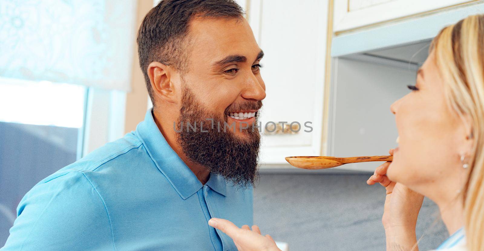 Couple in love preparing meal together in kitchen at home