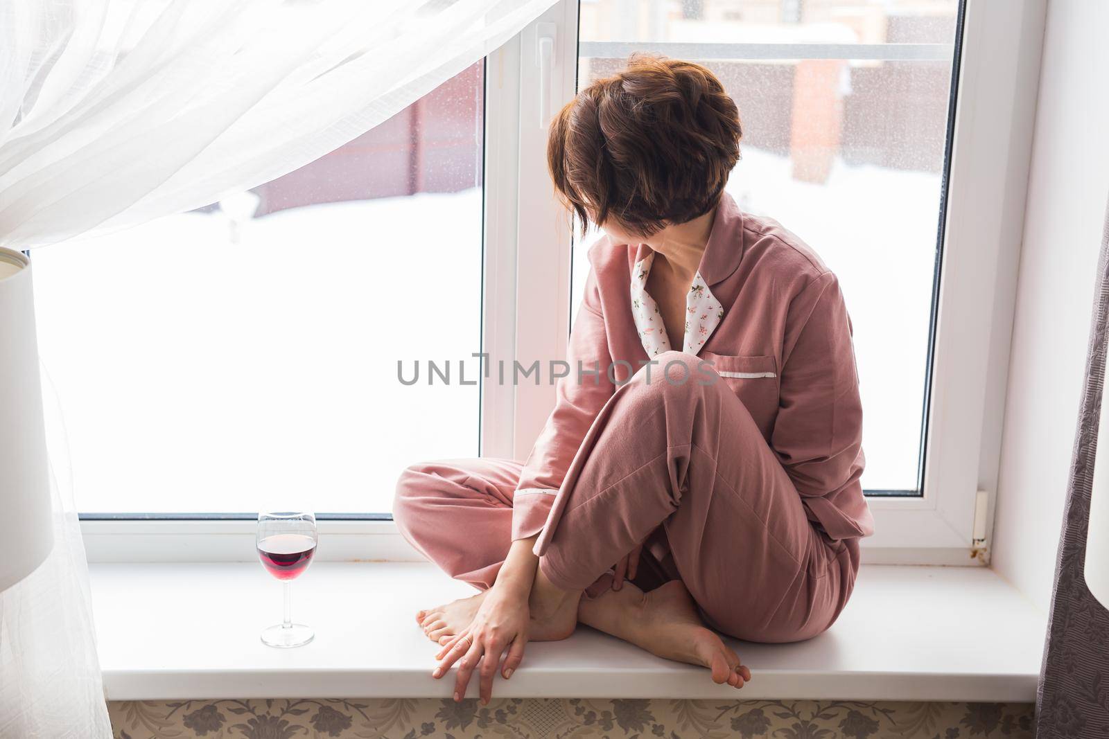 Young brunette woman relaxing at home reading book. Quarantine, isolation, coronavirus pandemic world. Stay home.