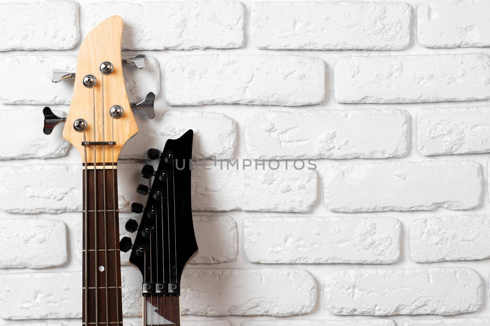 Guitar headstock with tuners on dark background close up