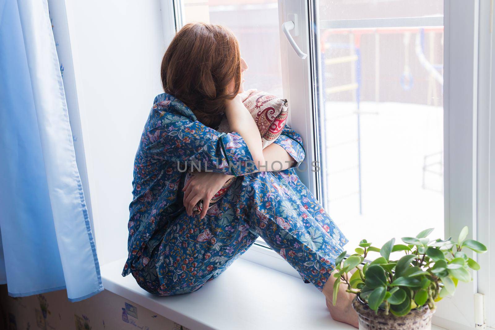 Young brunette woman relaxing at home reading book. Quarantine, isolation, coronavirus pandemic world. Stay home.