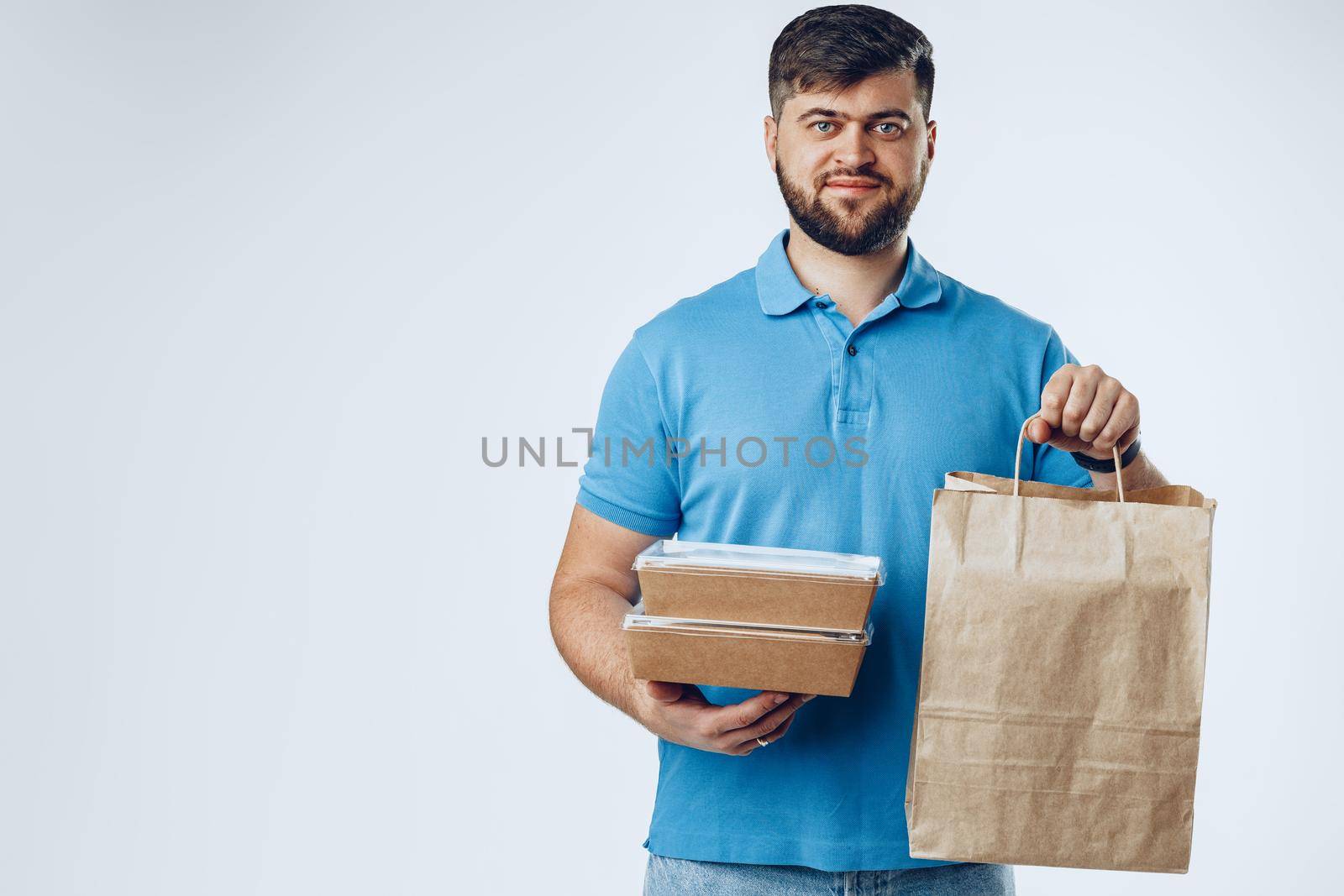 Food delivery courier with order on light grey background