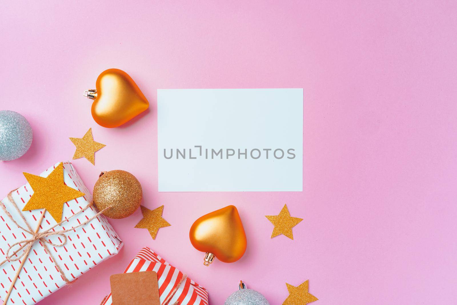 Christmas festive decorations with copy space on pink background, top view