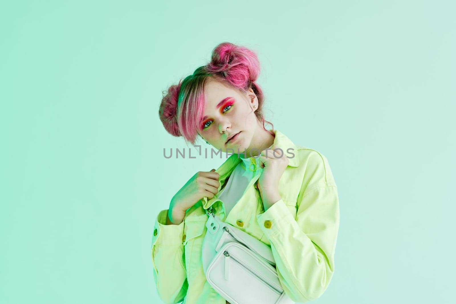 glamorous fashionable woman with pink hair posing hipster neon. High quality photo