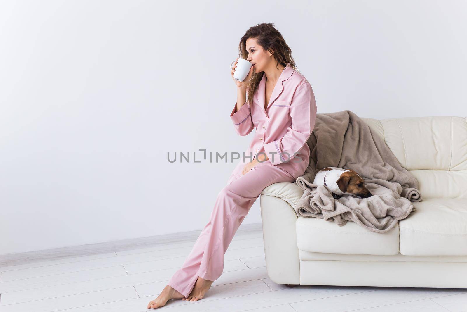 Glamorous girl with happy smile in good morning. Positive female model drinking hot tea.