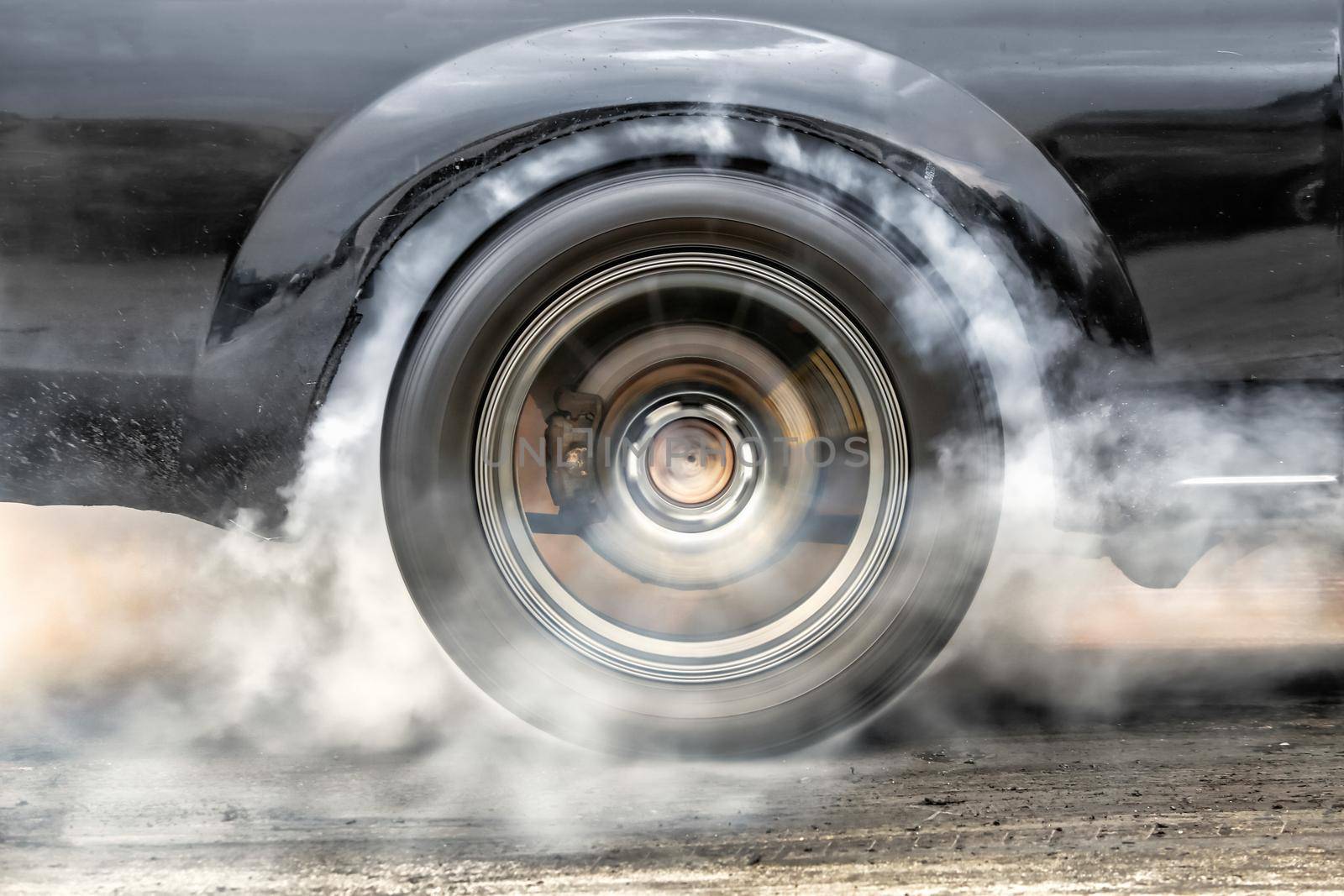 Drag racing car burns rubber off its tires in preparation for the race by toa55