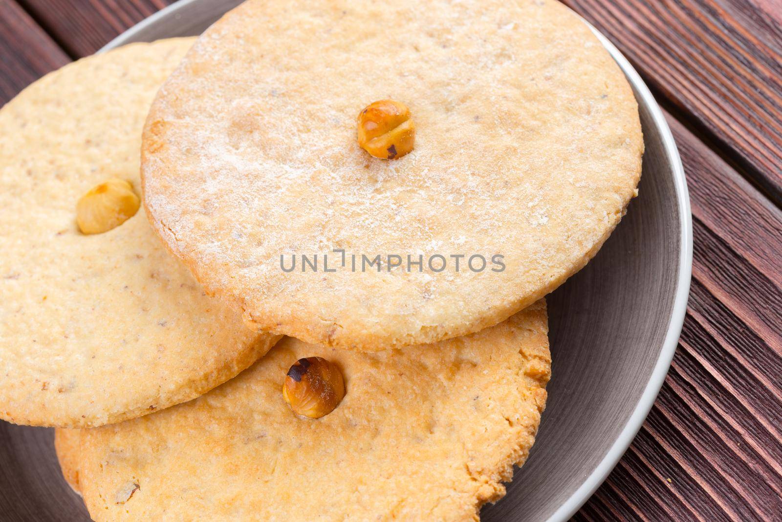 Oat cookies served on dark wooden table close up