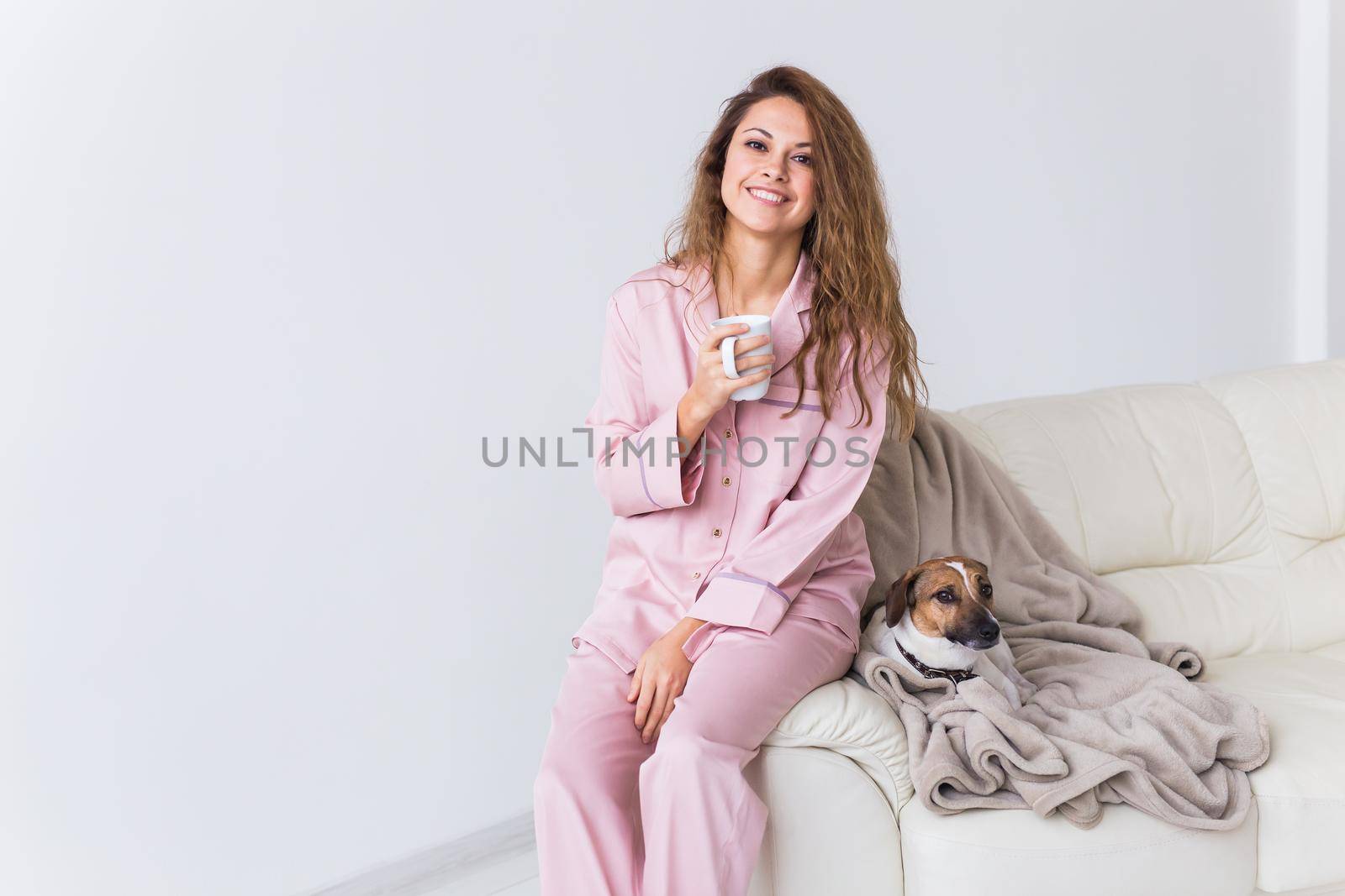Glamorous girl with happy smile in good morning. Positive female model drinking hot tea.