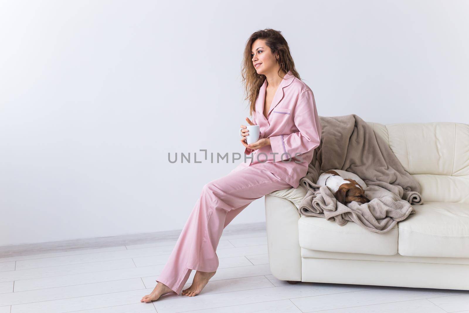 Glamorous girl with happy smile in good morning. Positive female model drinking hot tea.