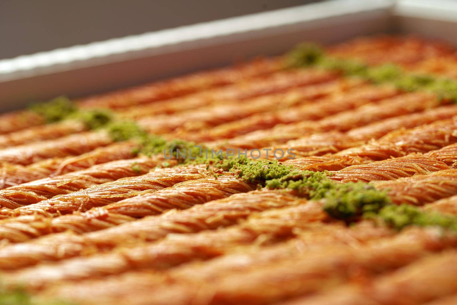 Close up photo of Turkish Baklava dessert with honey and nuts