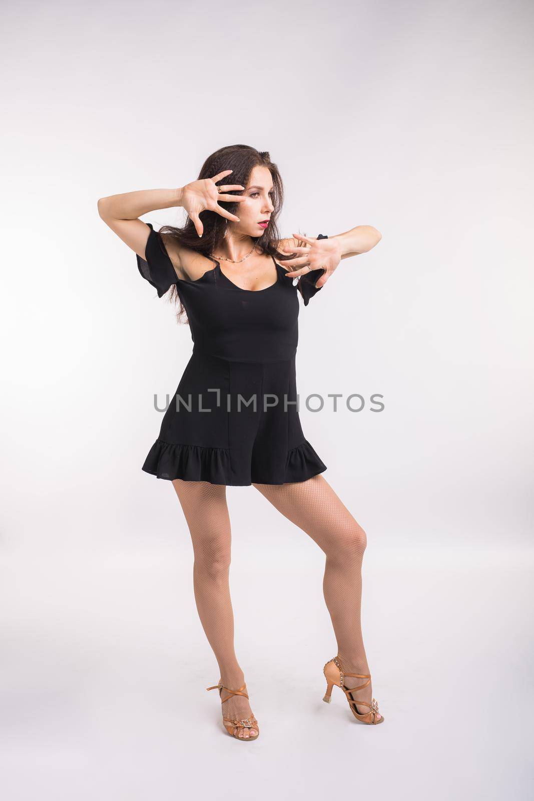 Latina dance, strip dance, contemporary and bachata lady concept - Woman dancing improvisation and moving her long hair on a white background