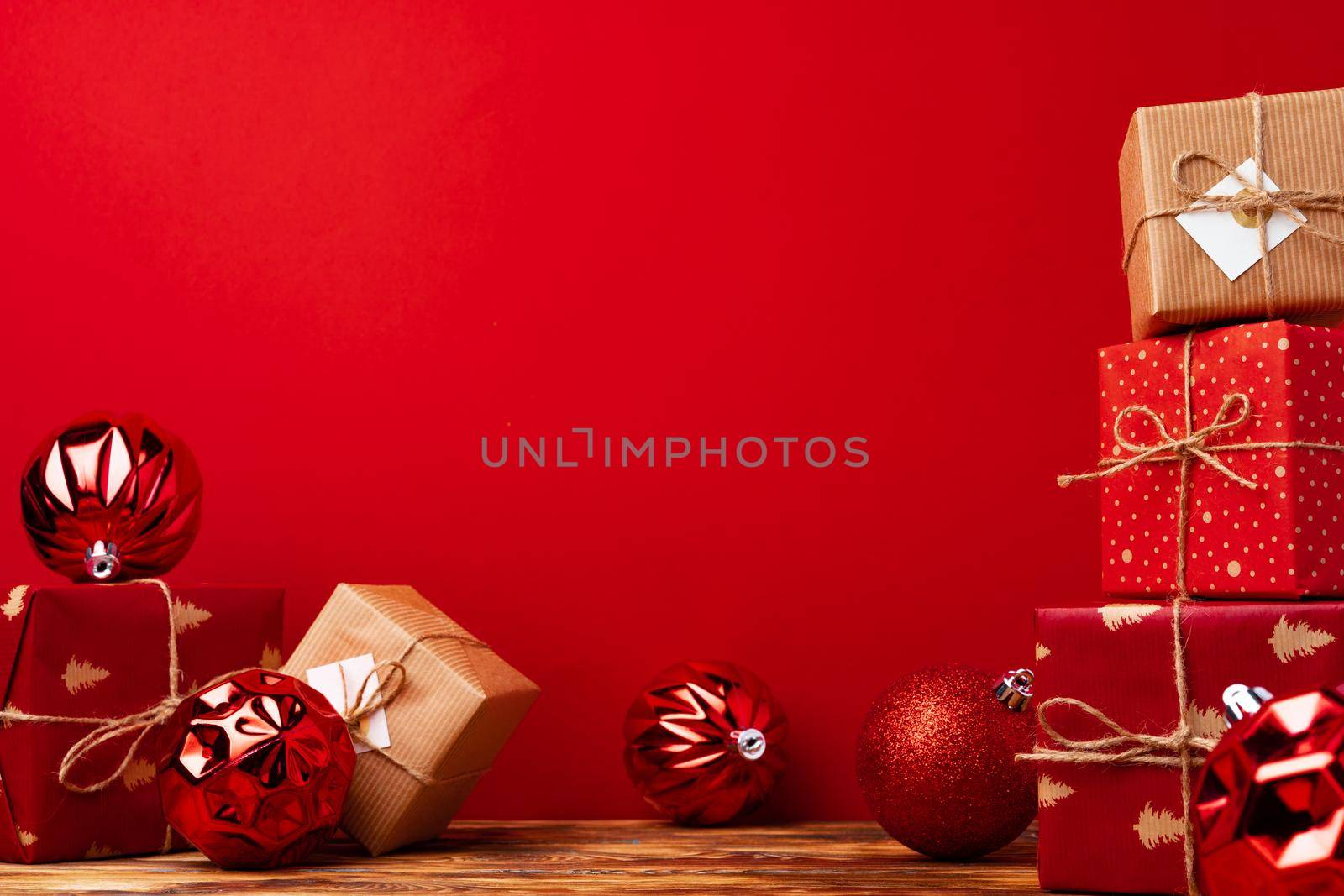 Wrapped christmas gift boxes against red background front view