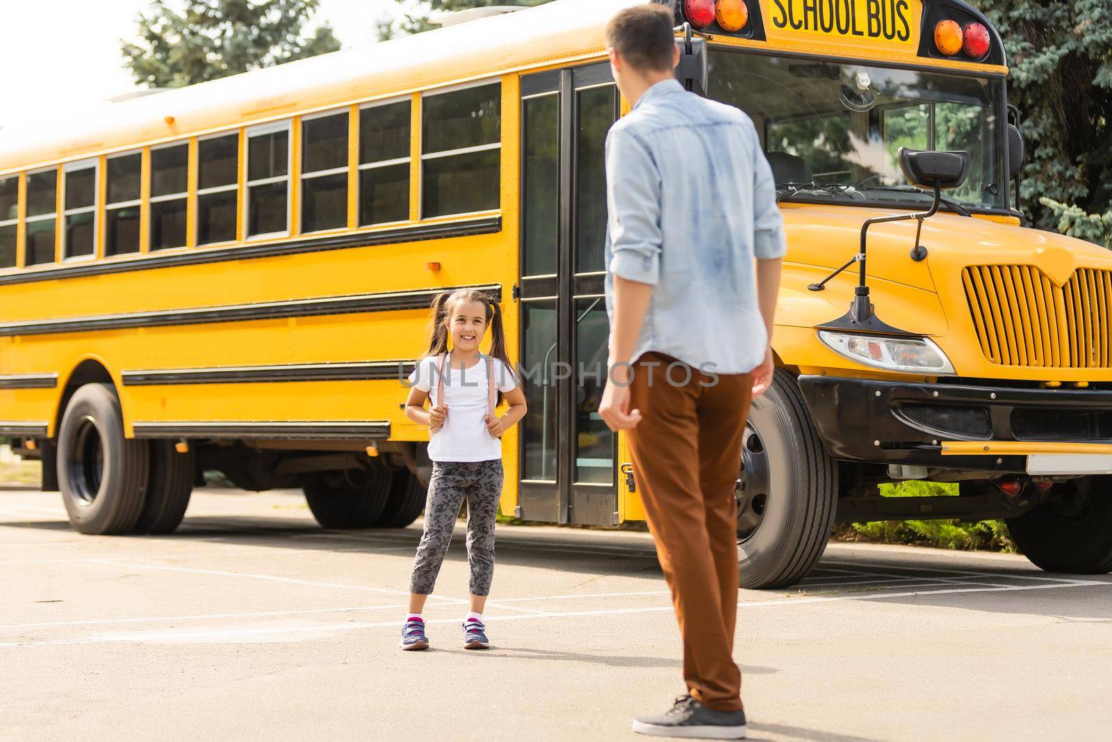 Happy day of back to school. Smiling father taking child to primary school. by Andelov13