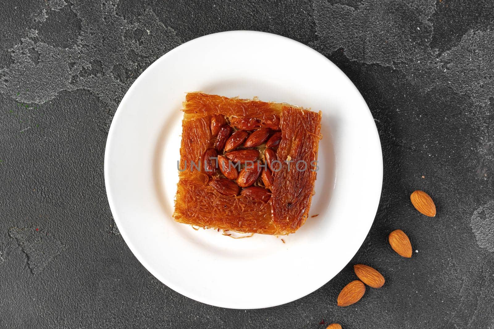 Turkish dessert baklava with nuts on black background, close up