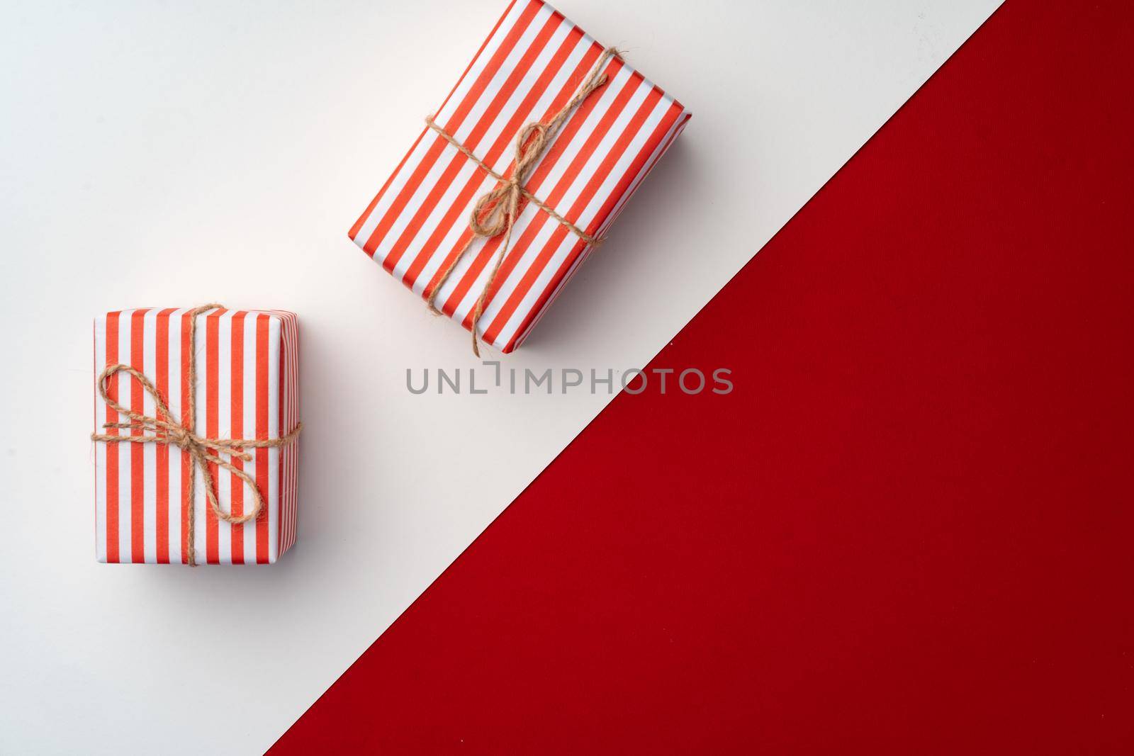Beautiful red and white composition with Christmas gifts, view from above