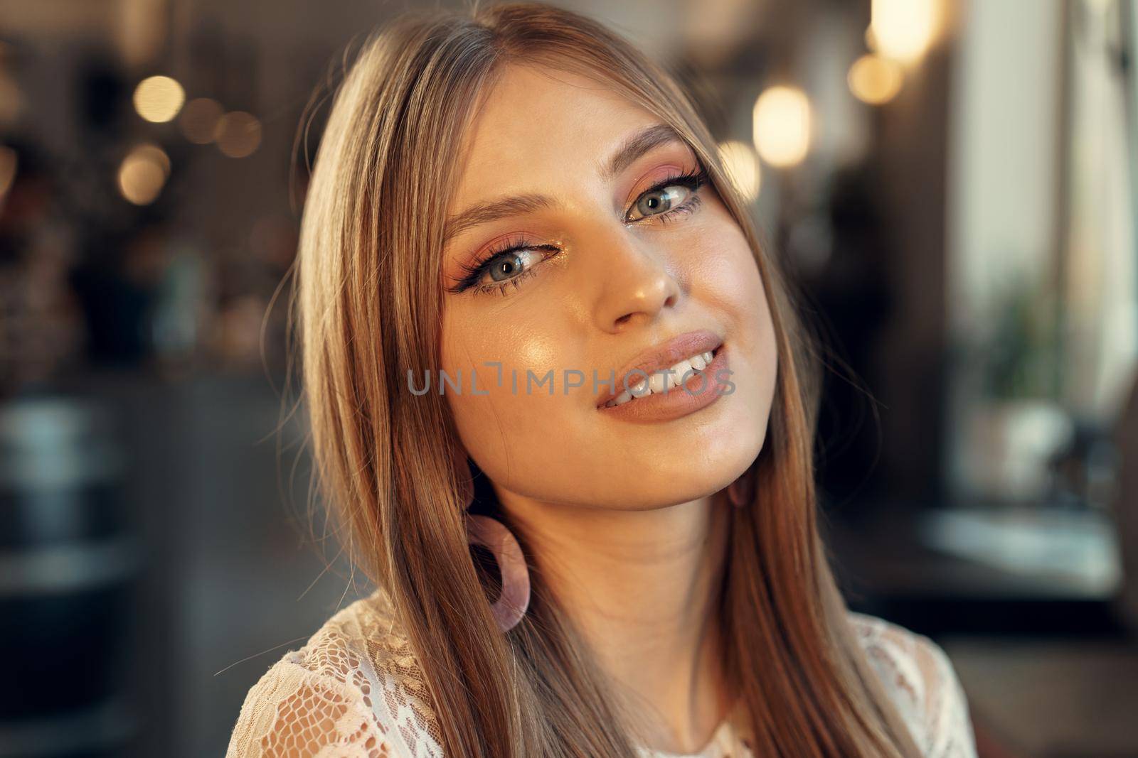 Beautiful female model portrait in a cafe. Close up.