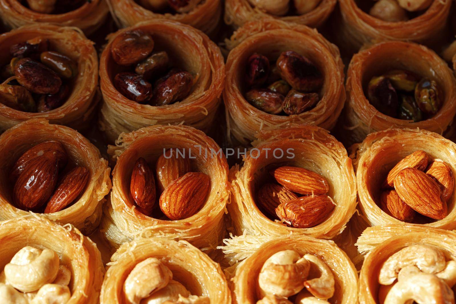 Background of assorted traditional arabic dessert Baklava with honey and nuts