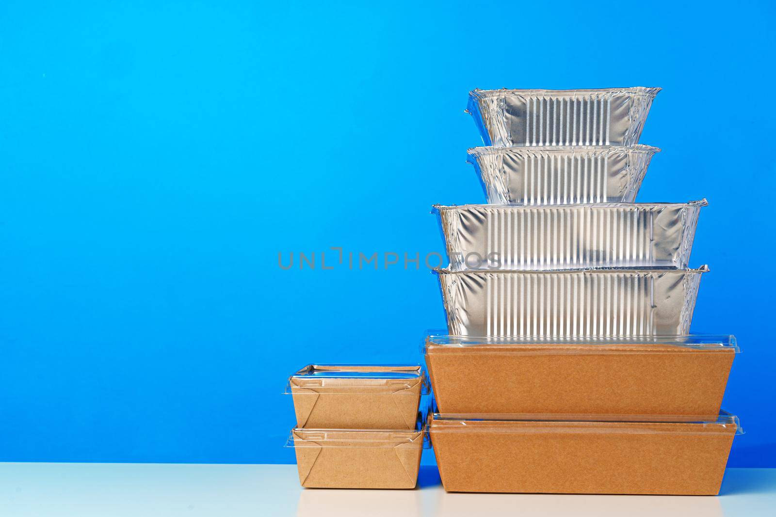 Assortment of various food delivery containers on table close up