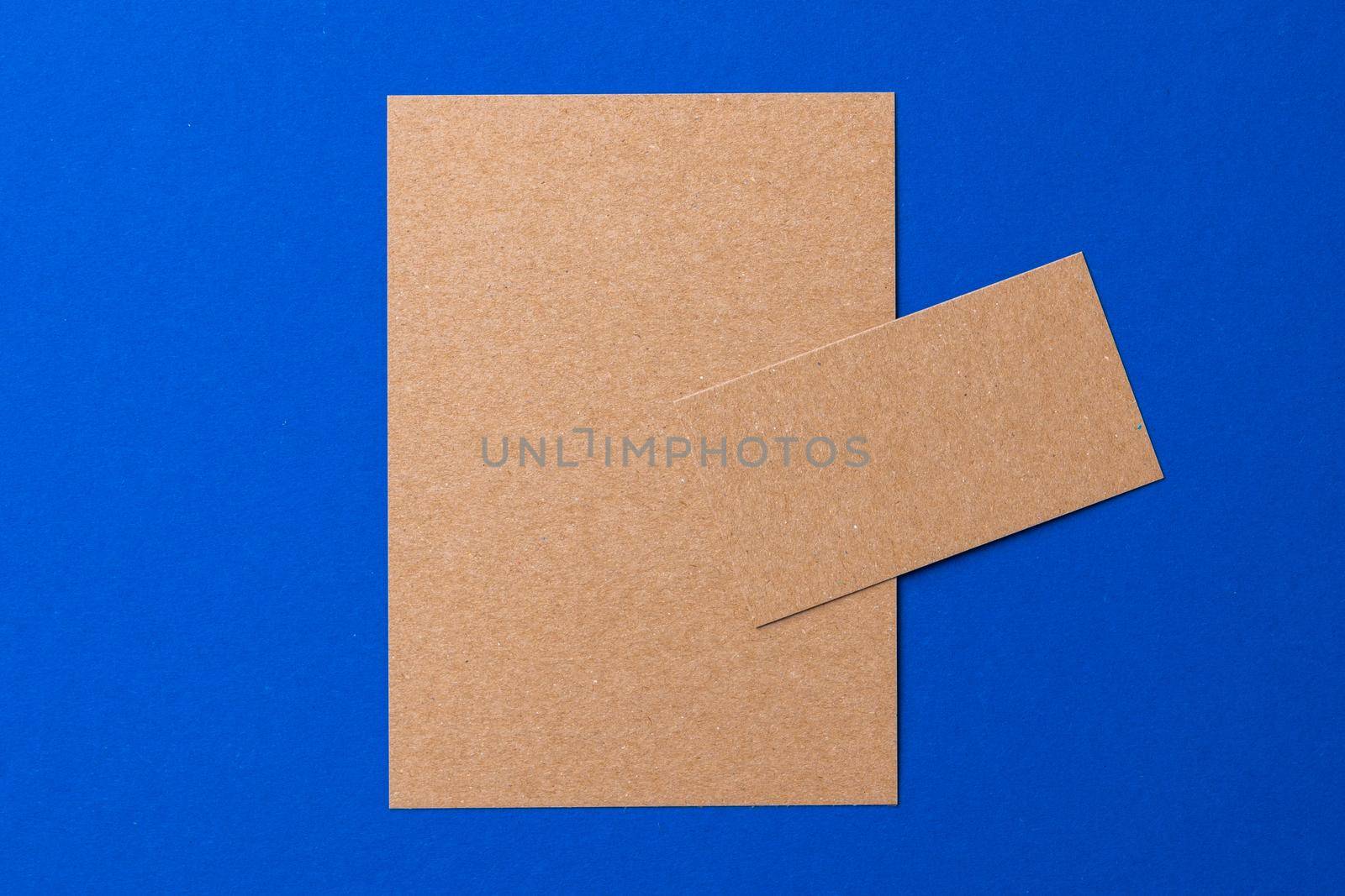 Blank paper business mock up on classic blue background, top view
