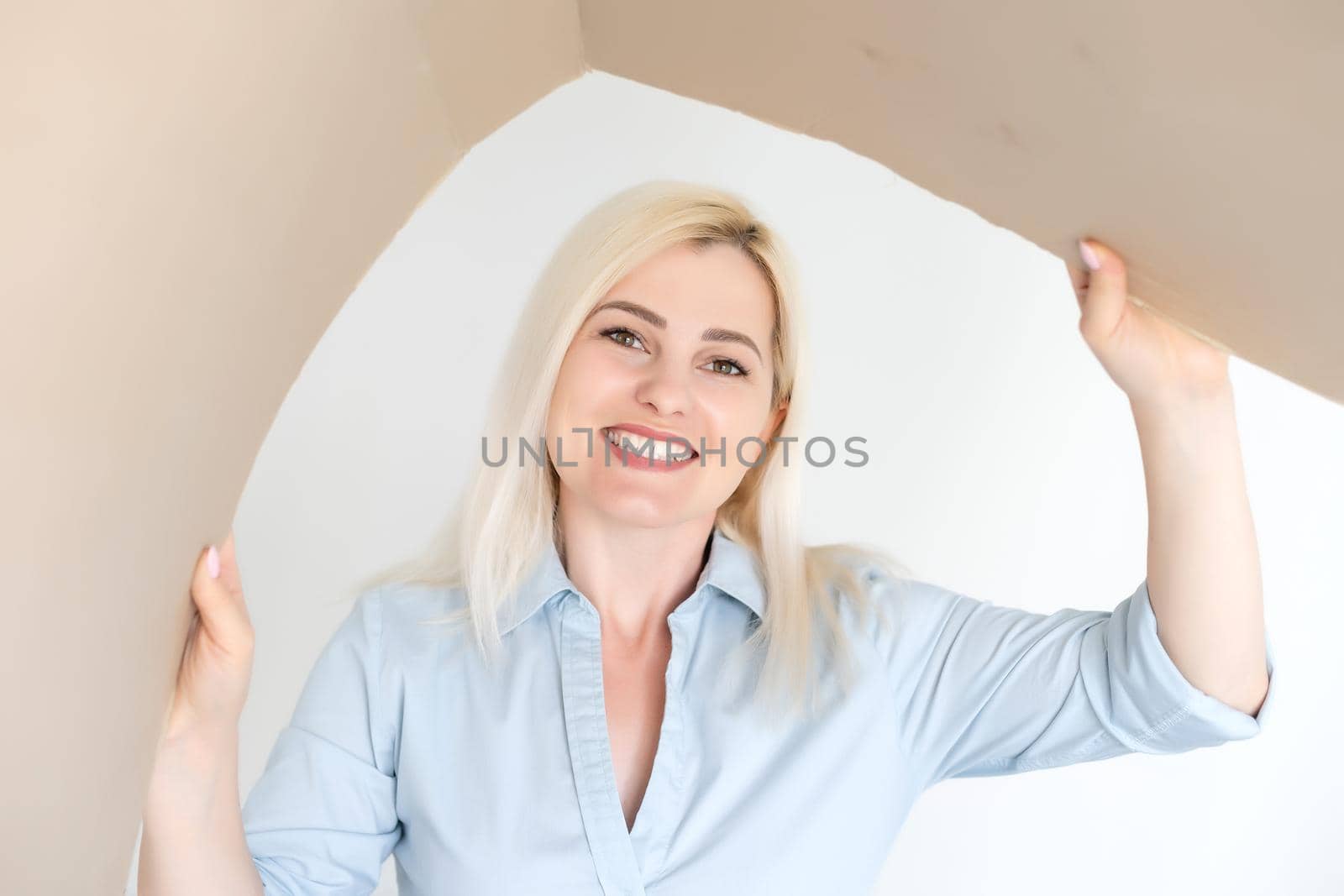 Pleasant woman opening cardboard box
