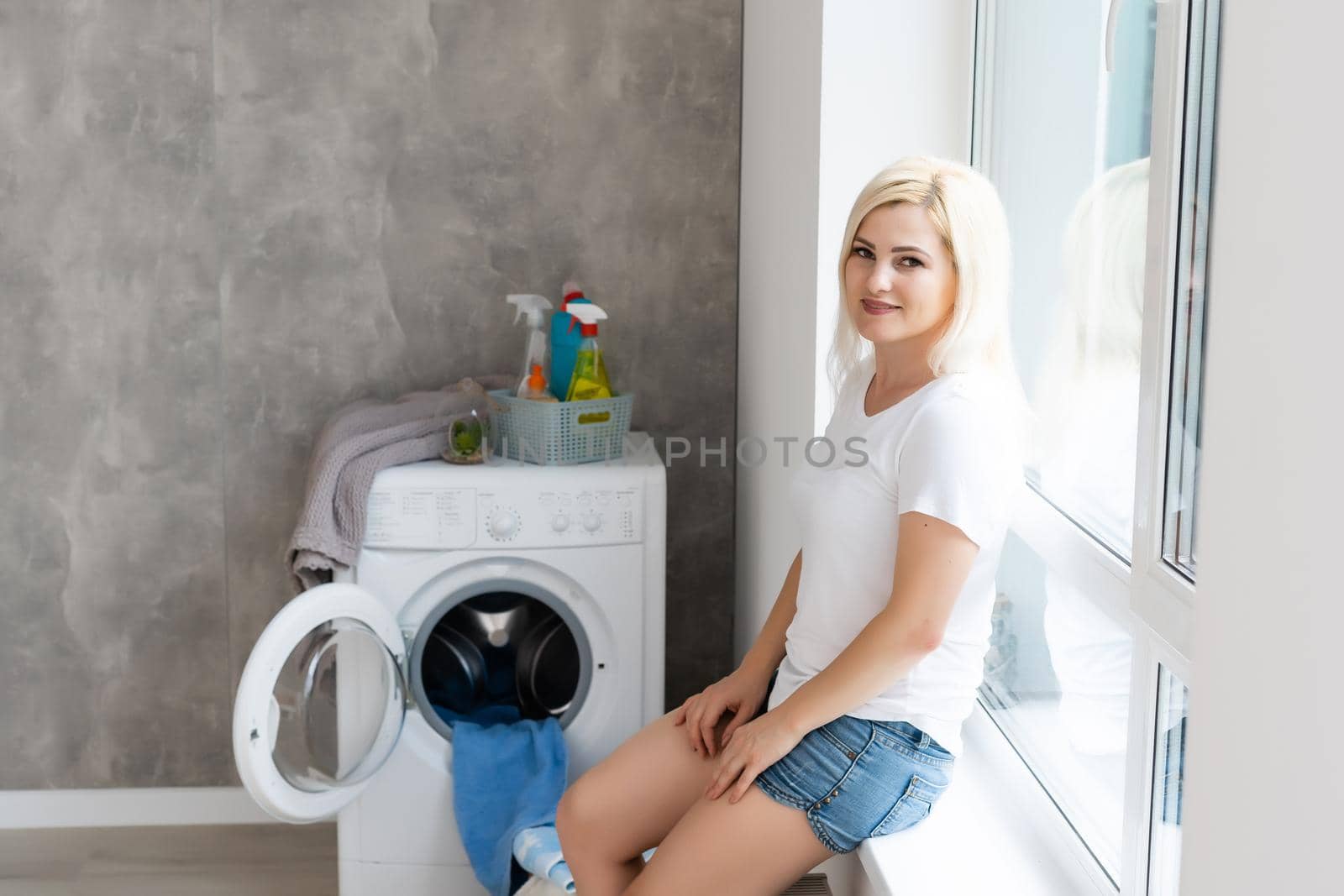 Housework, young woman doing laundry