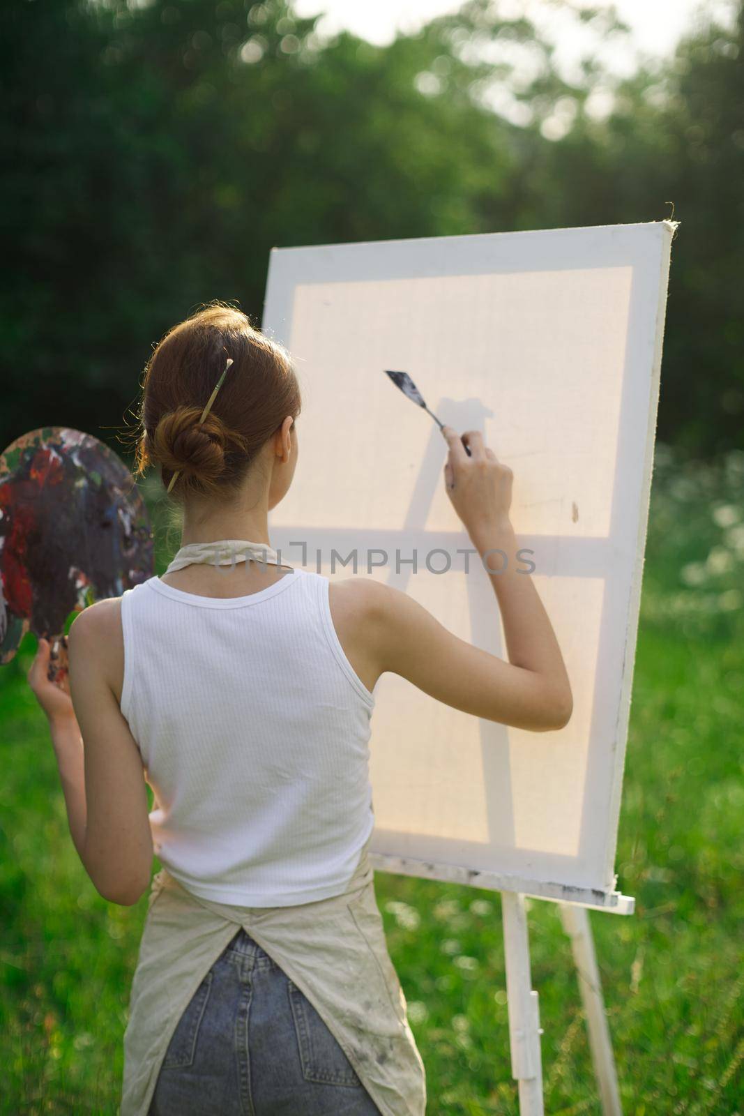 woman artist outdoors paint palette painting landscape. High quality photo