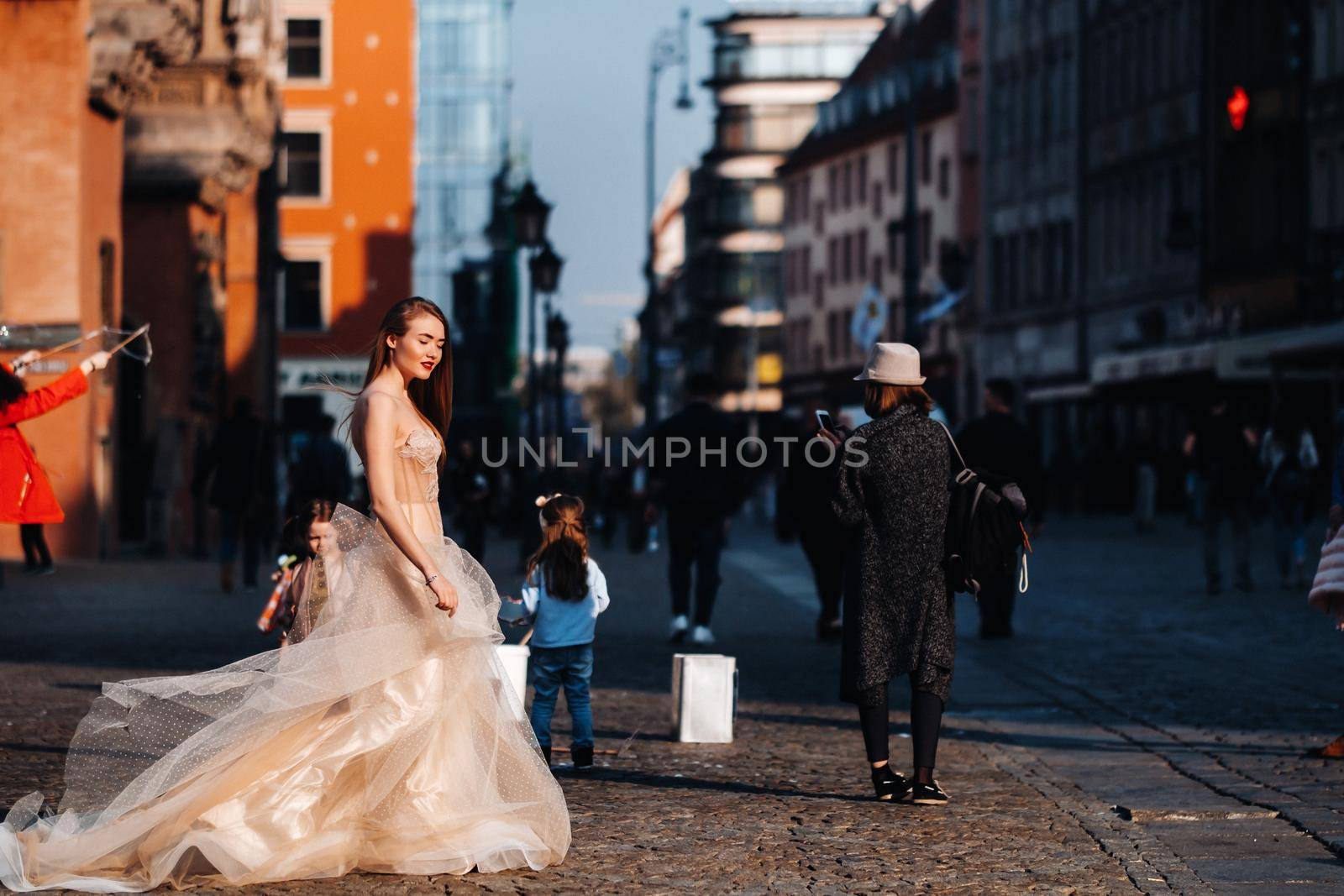 A bride in a wedding dress with long hair in the old town of Wroclaw. Wedding photo shoot in the center of an ancient city in Poland.Wroclaw, Poland by Lobachad