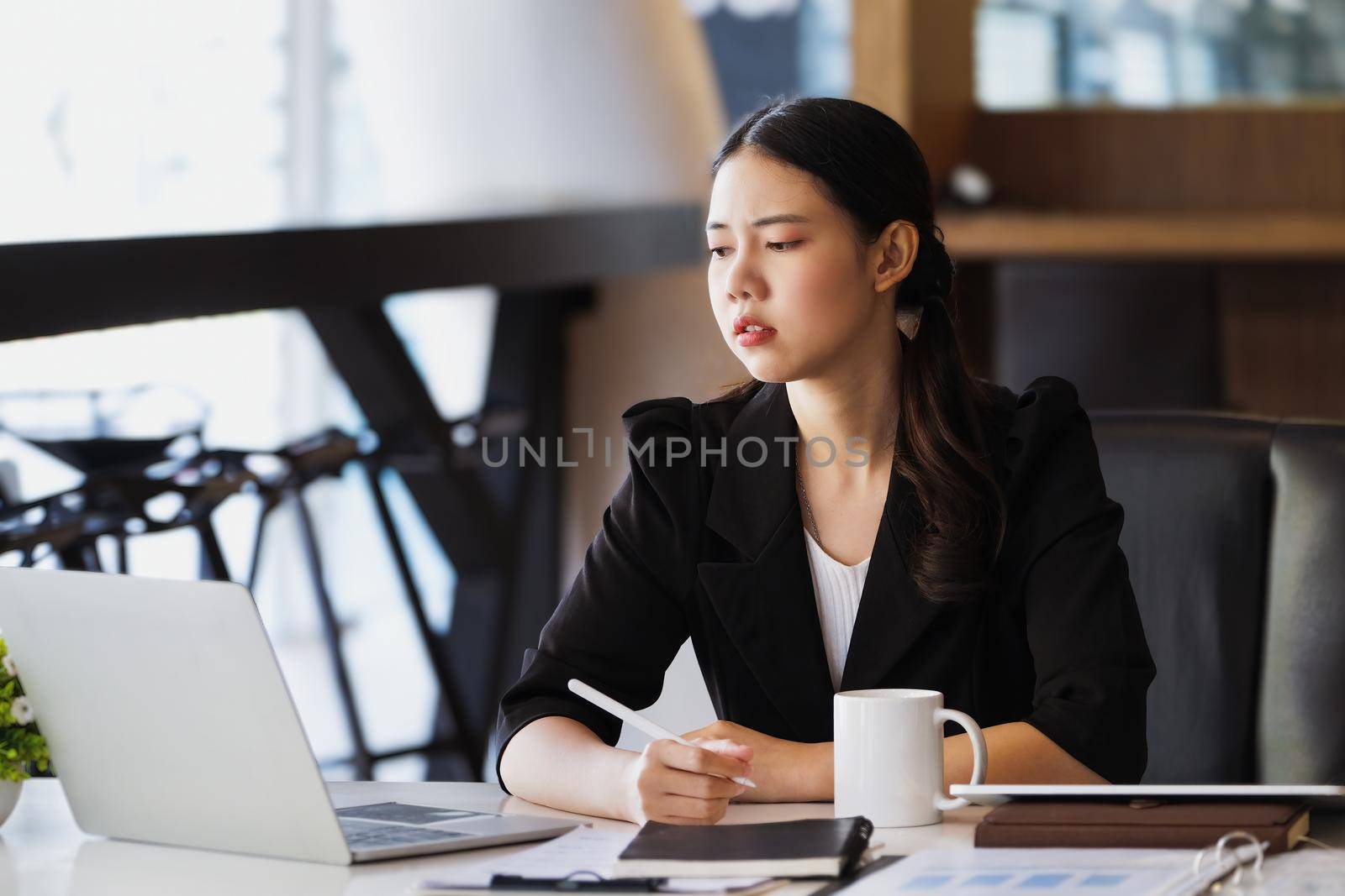 Company employees show boredom from unfinished work using computer notebook, documents and tablets at work