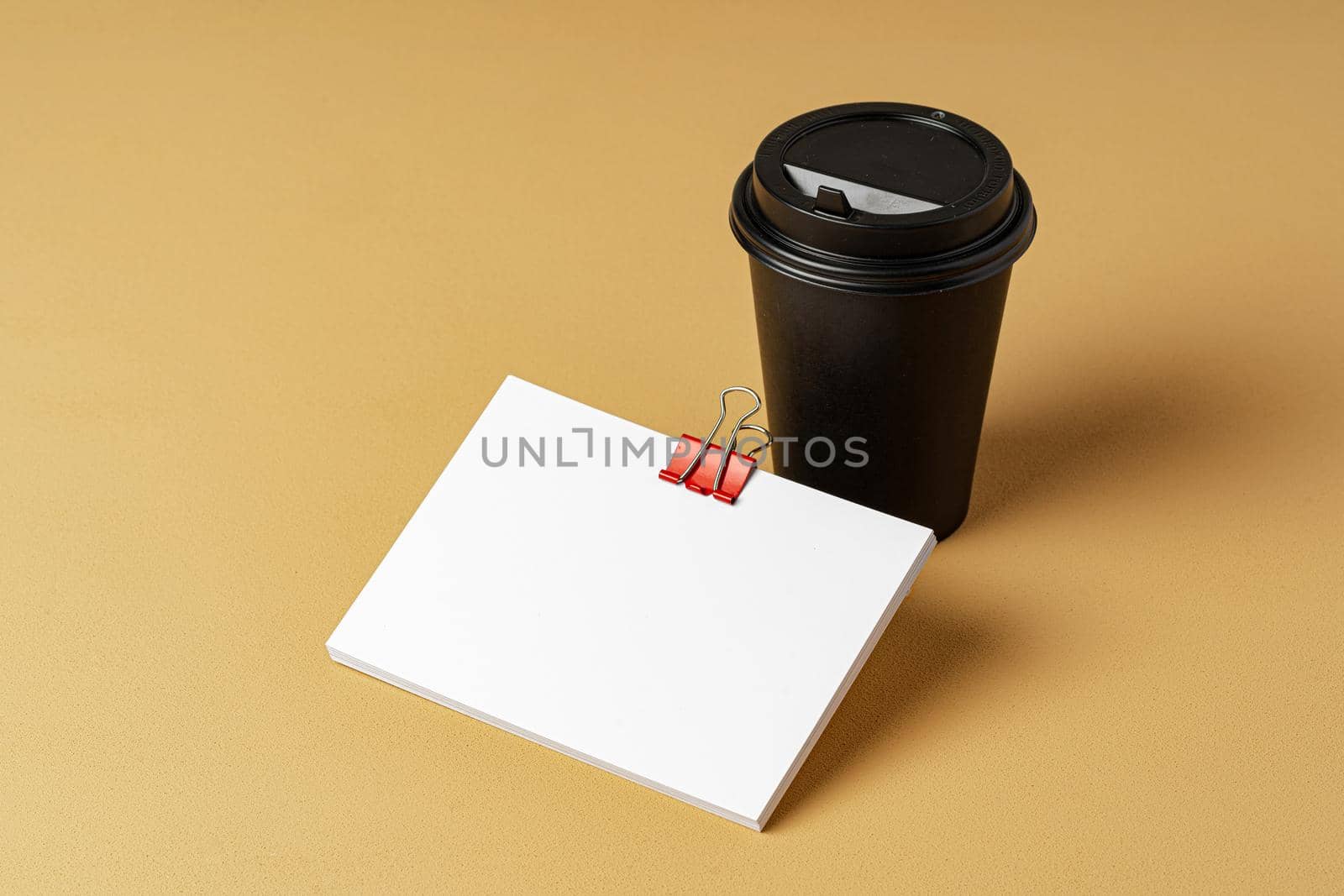 Blank takeaway coffee cup and white businesscards with copy space