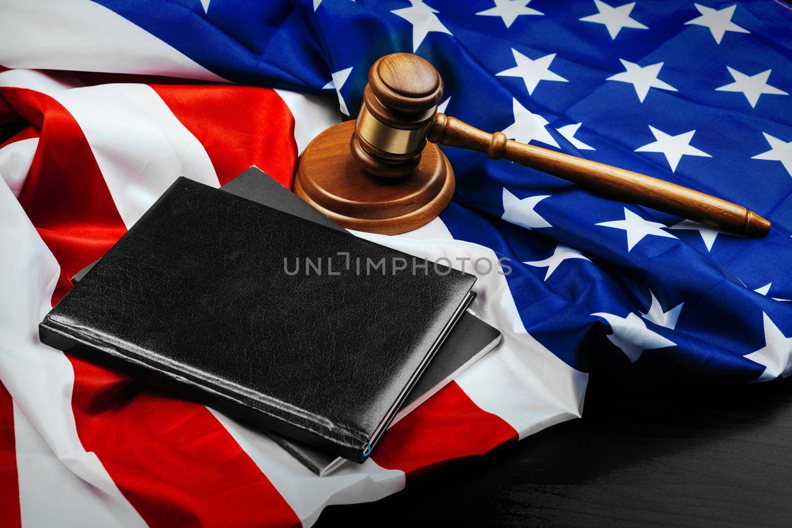 Gavel on wooden table with USA flag. Close up.