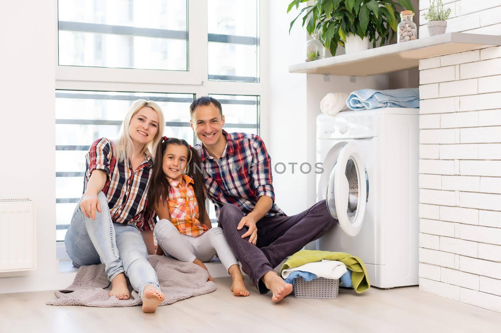 the image of a happy family doing laundry
