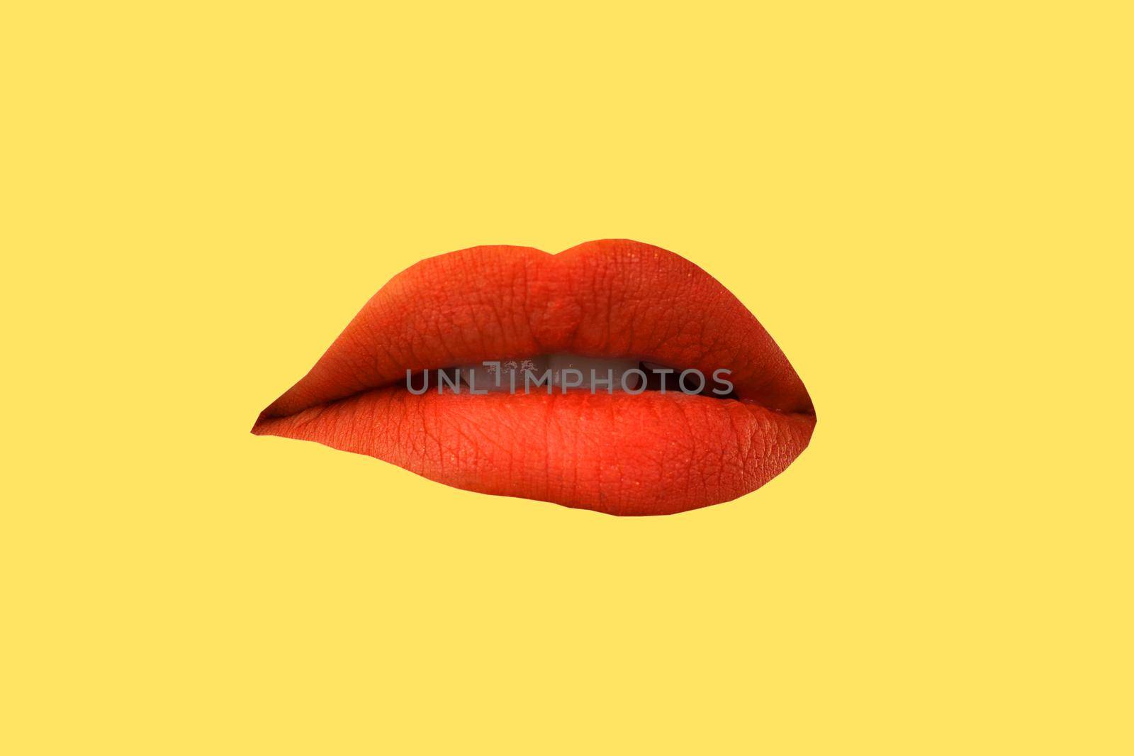 Woman's lips close up isolated on yellow background by zartarn