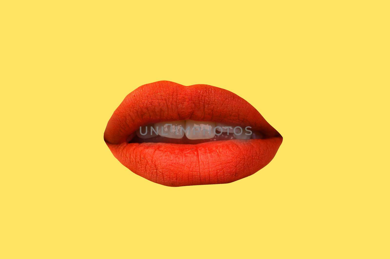 Woman's lips close up isolated on yellow background.