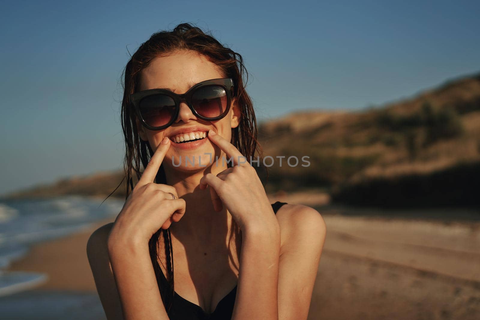 pretty woman in black swimsuit beach nature sun. High quality photo