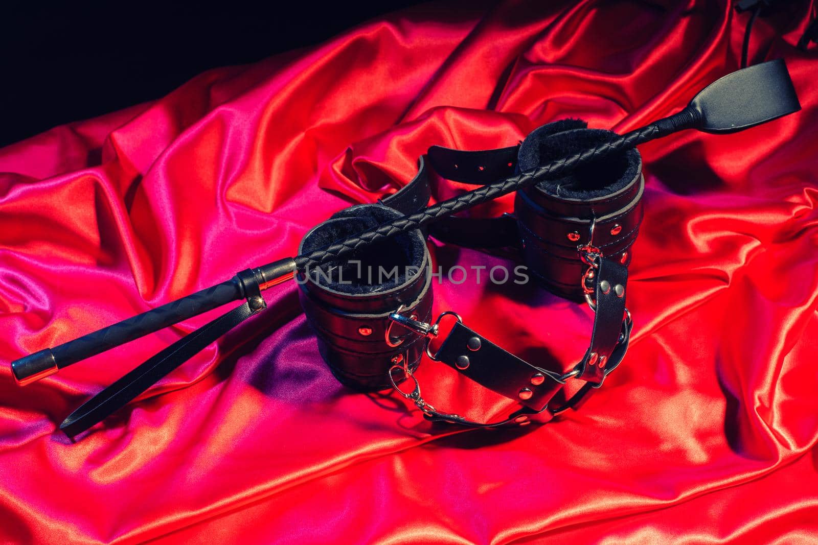 Adult sex games. Kinky lifestyle. Spank and Bondage on the red linen. Bdsm outfit - Image