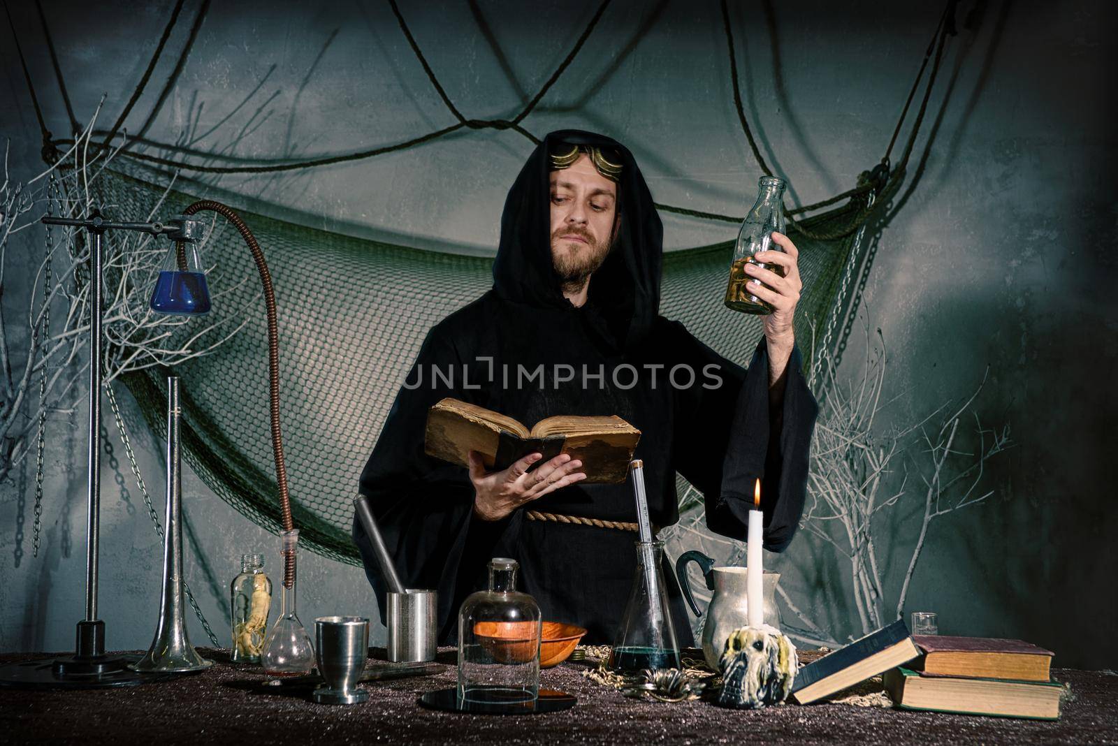 The medieval scientist medieval scientist in his lab reads a spell. Halloween