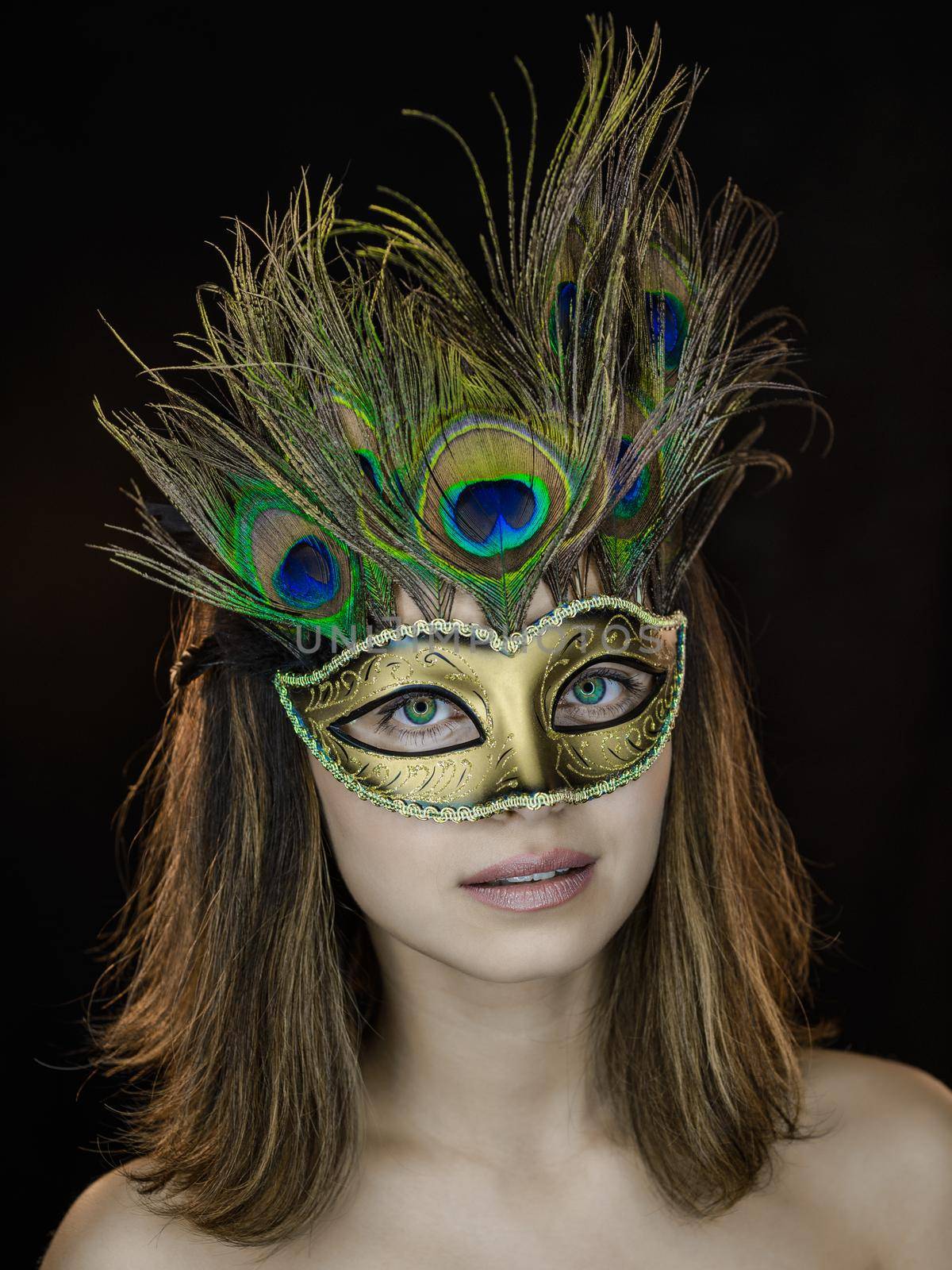 Close-up portrait of a beautiful green-eyed woman in a Venetian carnival mask by zartarn