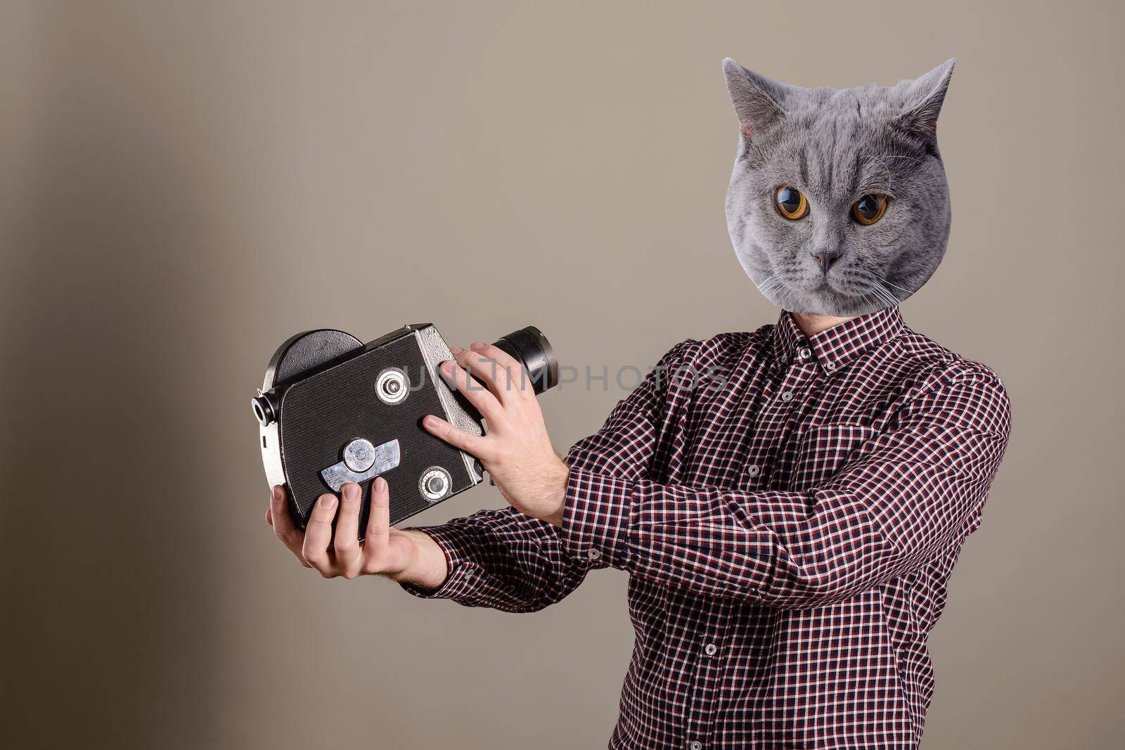 Collage of young attractive cameraman in a plaid shirt and a cat head takes himself off to an old movie camera.