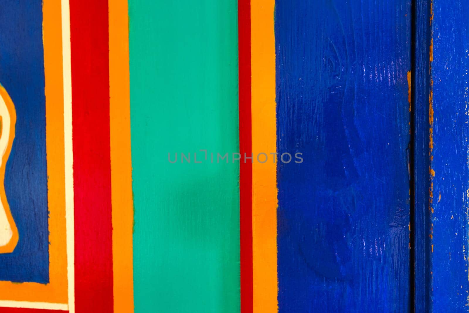 Bright colorful wooden door painted various colors of the rainbow background texture, IBIZA style macro closeup, cheerful design beauty