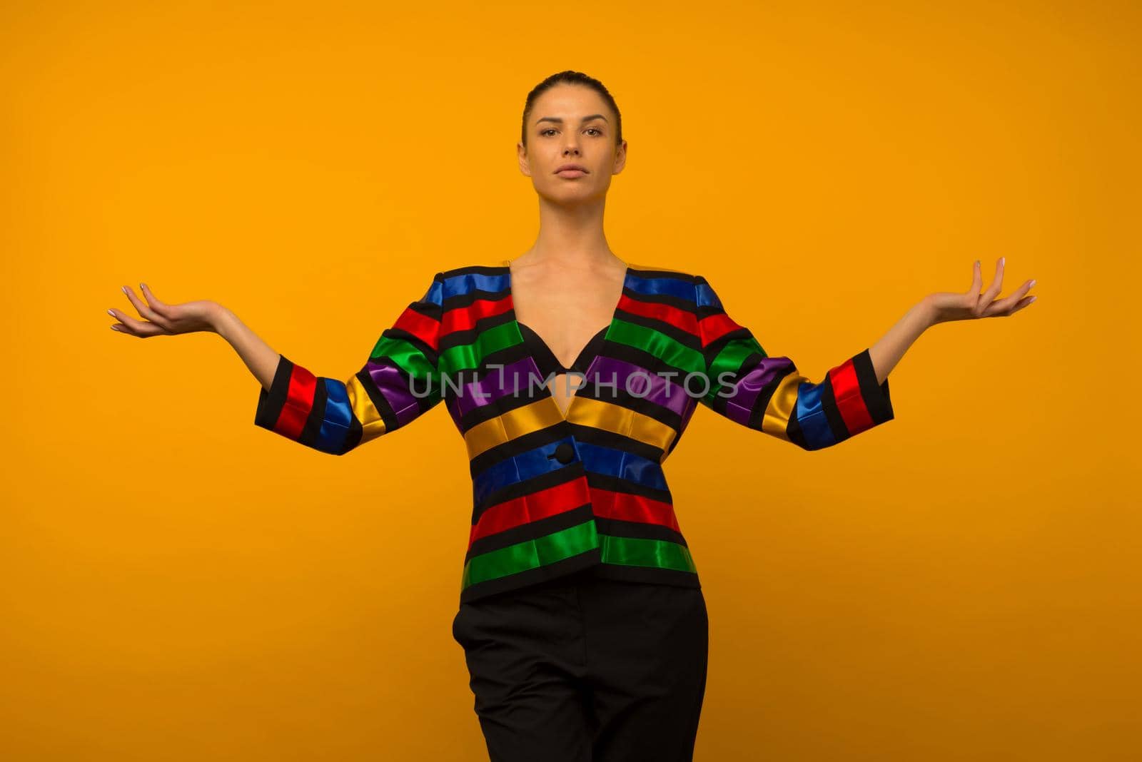 Young lesbian girl and an LGBT community representative posing in a flag coloring jacket LGBTQ shows something - image