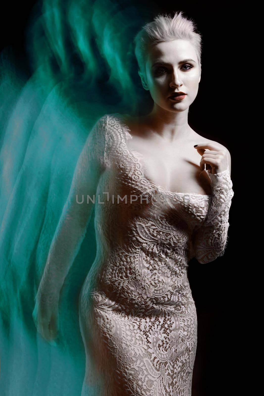 Beautiful girl in white lace negligee. A trace from a mixed light. The Snow Queen. Low key