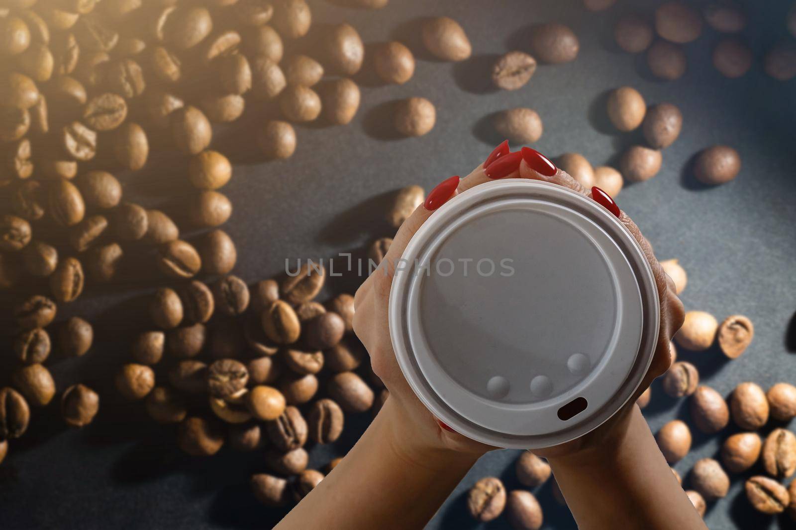 takeaway cup with coffee and coffee beans.
