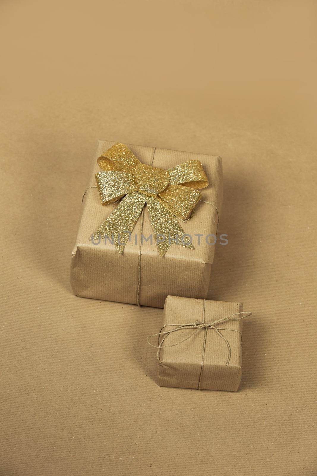 Brown paper gift boxes with gold ribbon wrapping decoration for birthday, Valentine's day, mother's day other party concept background texture, retro design sparkles